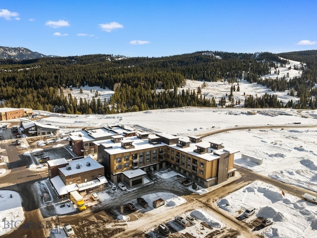 211 Town Center Ave Unit 2D, Big Sky, MT 59716 - snowy aerial view with a view of trees and a mountain view