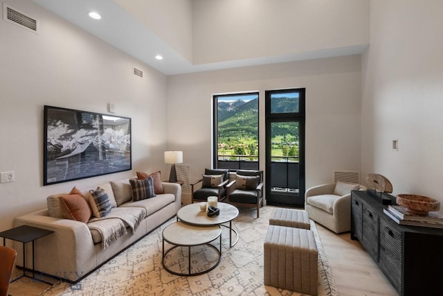 living room featuring a towering ceiling