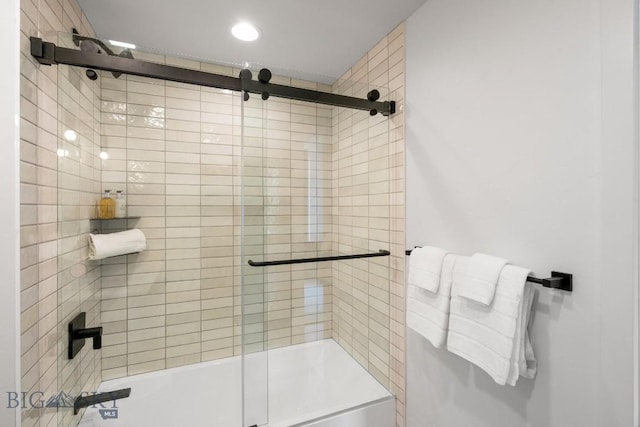 bathroom with bath / shower combo with glass door