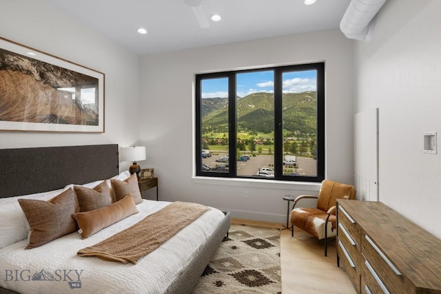 bedroom featuring multiple windows and light wood-type flooring