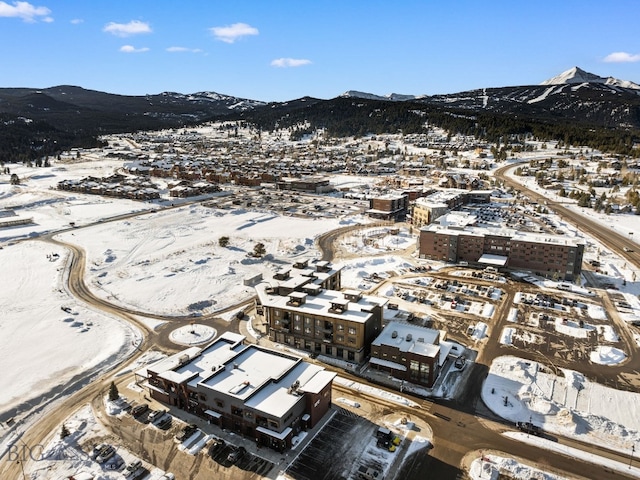 snowy aerial view with a mountain view