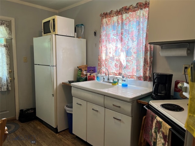 kitchen featuring dark hardwood / wood-style flooring, white cabinets, sink, white appliances, and ornamental molding