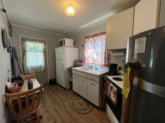 kitchen featuring white appliances, crown molding, white cabinets, dark hardwood / wood-style floors, and sink