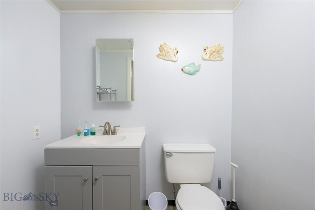 413 E 4th St, Anaconda, MT 59711 - bathroom with vanity, toilet, and ornamental molding