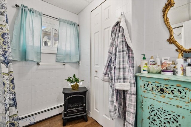 413 E 4th St, Anaconda, MT 59711 - bathroom featuring hardwood / wood-style flooring and a baseboard heating unit
