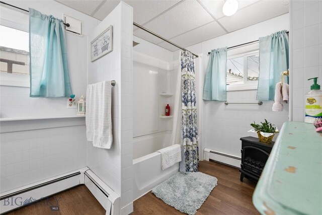 413 E 4th St, Anaconda, MT 59711 - bathroom with hardwood / wood-style floors, a baseboard radiator, a drop ceiling, and shower / bath combo