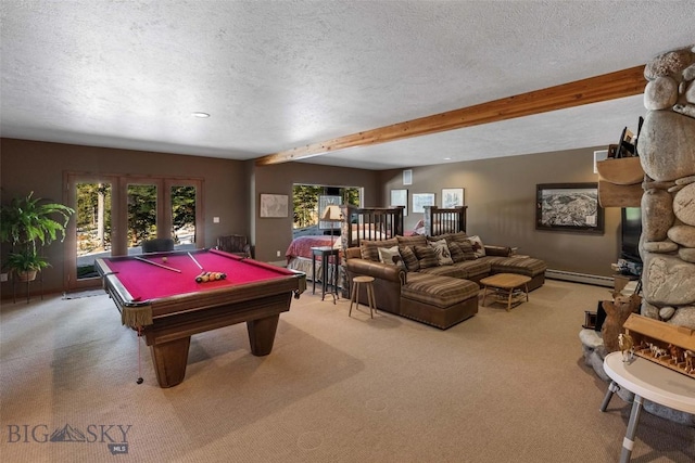 playroom featuring beam ceiling, light colored carpet, a textured ceiling, and a healthy amount of sunlight