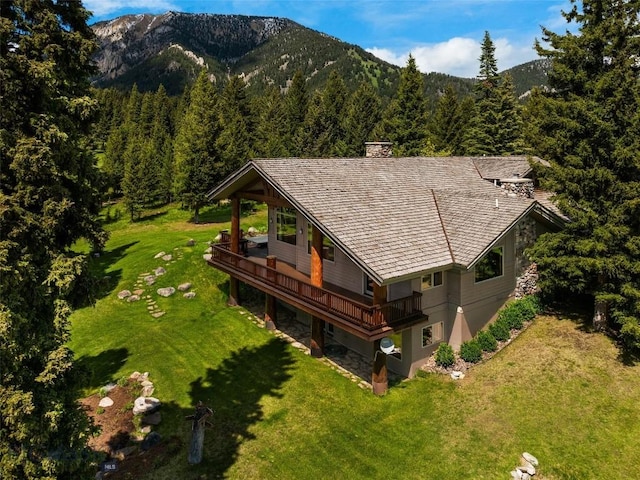 birds eye view of property featuring a mountain view and a wooded view