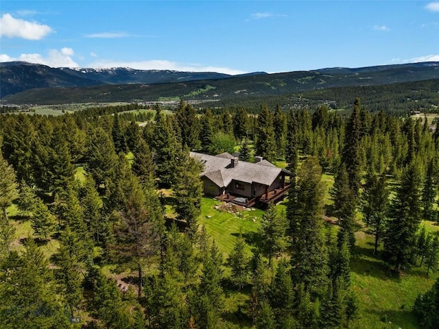 aerial view with a mountain view and a forest view