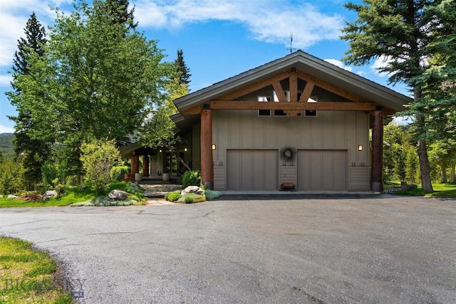 view of front of property featuring aphalt driveway and a garage