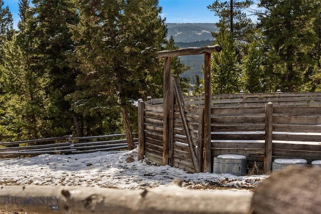 view of yard featuring a mountain view and fence