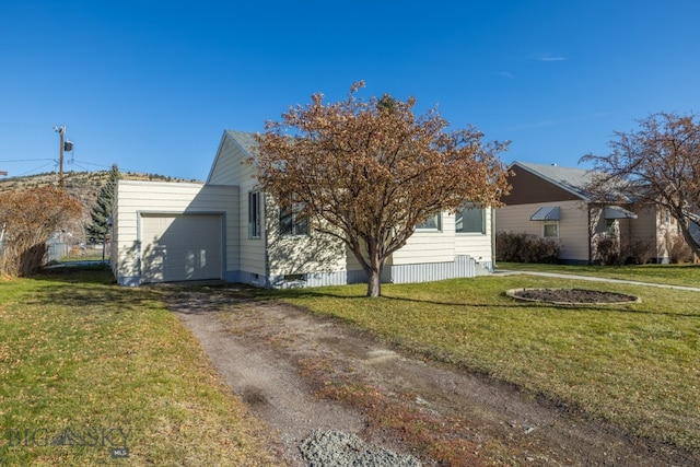 exterior space featuring a lawn and a garage