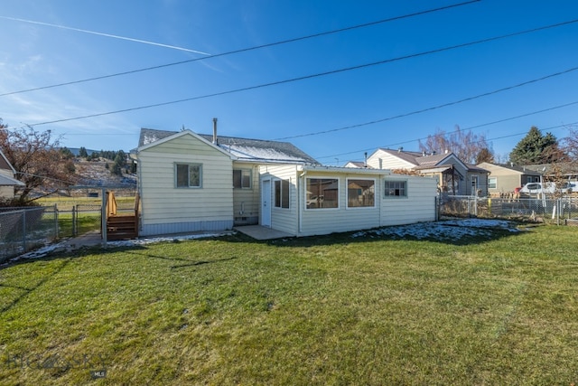 rear view of house with a lawn