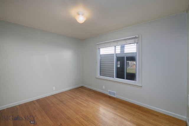 empty room with light hardwood / wood-style flooring