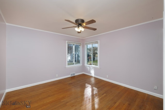 spare room featuring dark hardwood / wood-style floors, ornamental molding, and ceiling fan