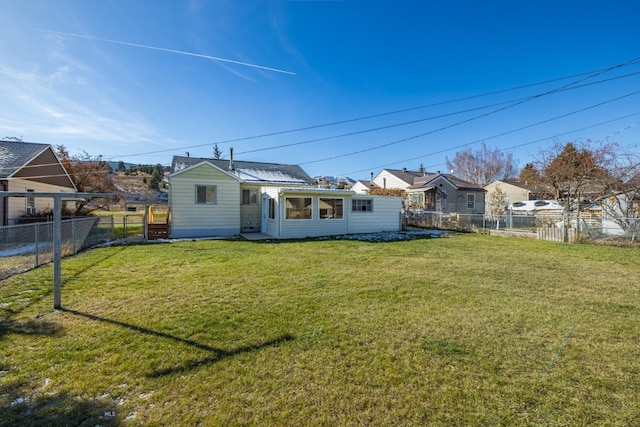 rear view of property featuring a yard