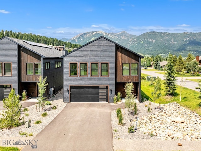 contemporary house with a mountain view and a garage