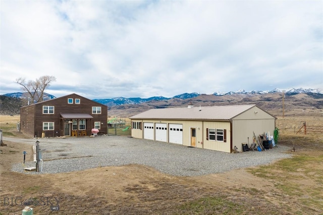 view of front of property with a garage, an outbuilding, and a mountain view