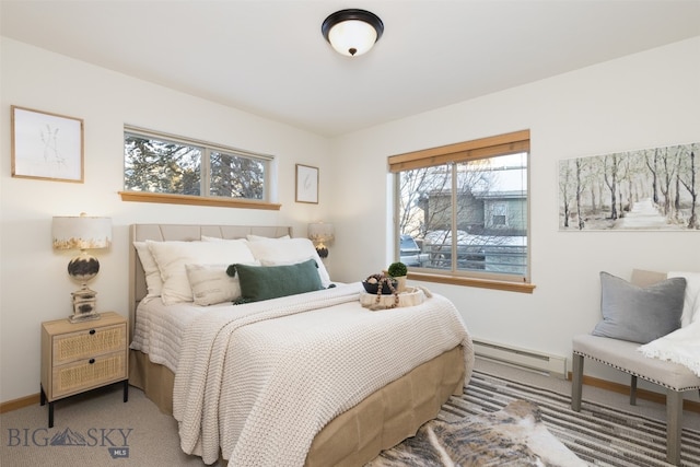 carpeted bedroom with baseboard heating and multiple windows