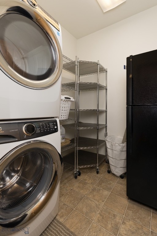 laundry room featuring tile patterned flooring and stacked washer / drying machine