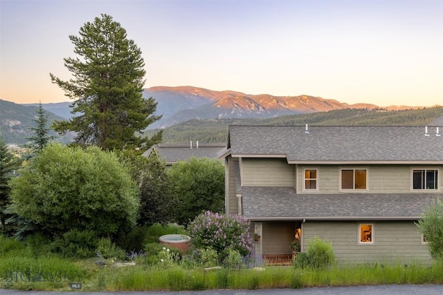 back house at dusk featuring a mountain view