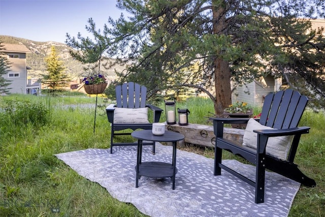 view of property's community with a mountain view and a patio area