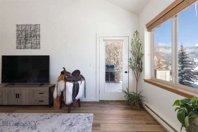 living room featuring dark hardwood / wood-style flooring, baseboard heating, and lofted ceiling