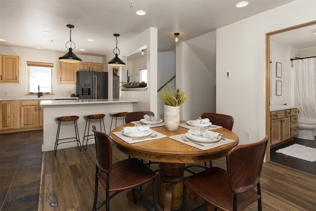 dining area featuring dark wood-type flooring and sink