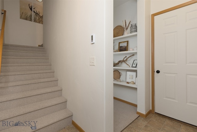 stairs featuring tile patterned flooring