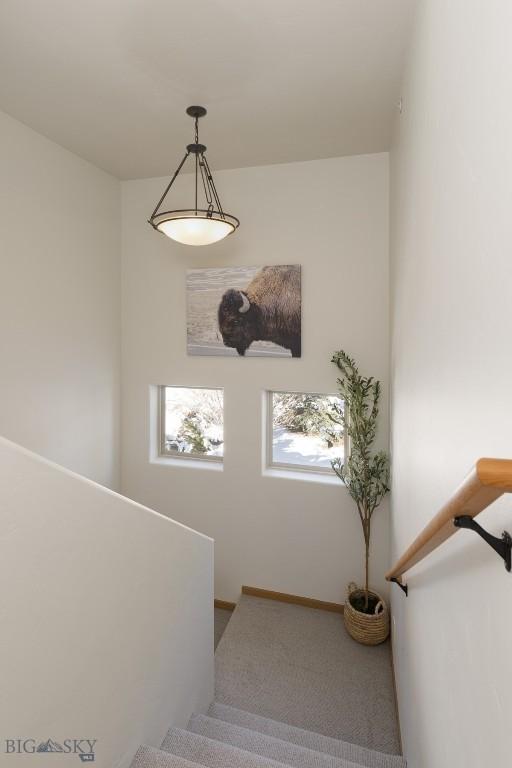 stairway featuring baseboards
