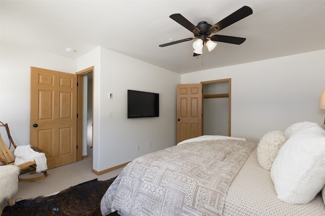 carpeted bedroom featuring ceiling fan and a closet