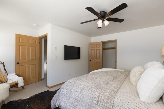carpeted bedroom featuring ceiling fan and baseboards