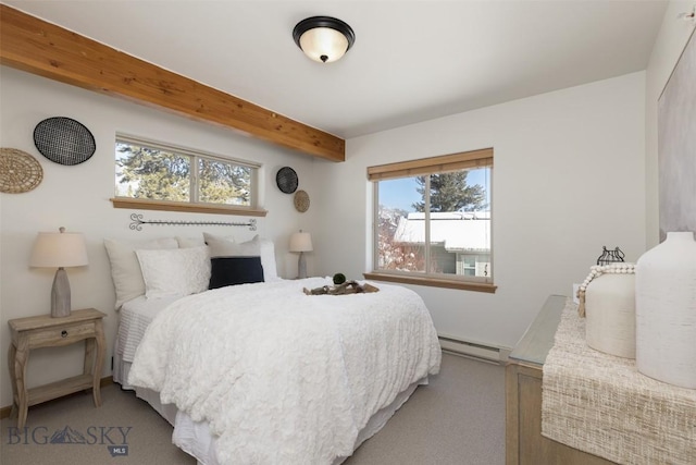 carpeted bedroom with a baseboard radiator and beamed ceiling