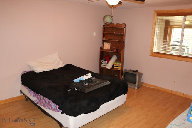 bedroom with ceiling fan and wood-type flooring