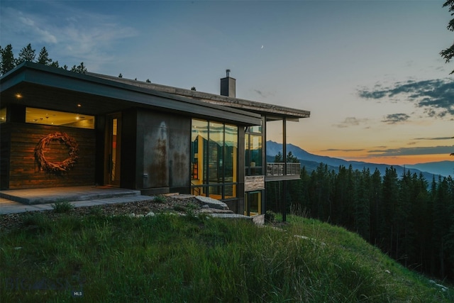 view of back house at dusk