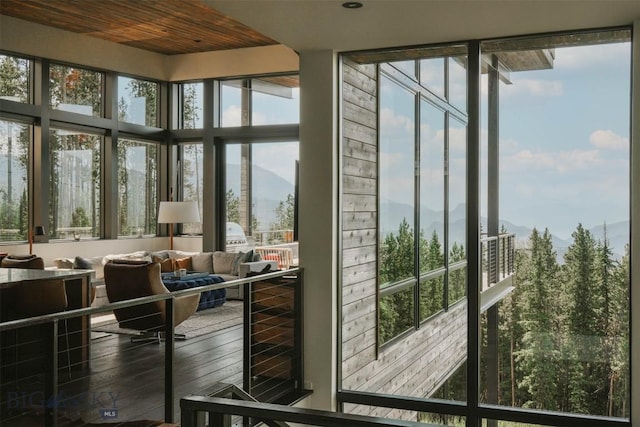 entryway with plenty of natural light, wine cooler, and wood finished floors