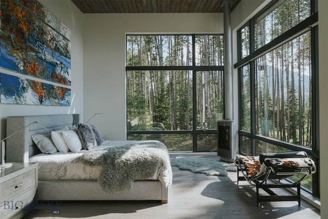 bedroom with wooden ceiling and wood finished floors