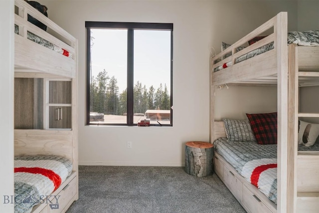 bedroom featuring carpet flooring and baseboards