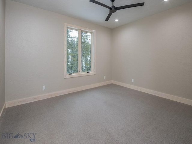 carpeted spare room featuring ceiling fan