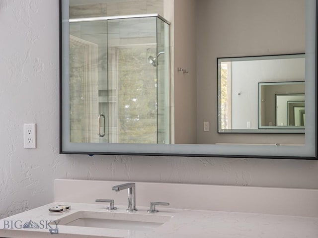 bathroom featuring vanity and a shower with shower door