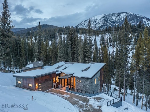 view of front of home with a mountain view and a garage