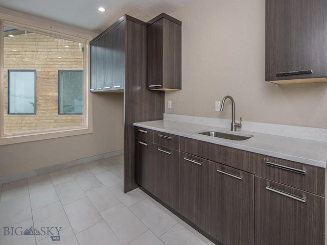 kitchen featuring sink and dark brown cabinets