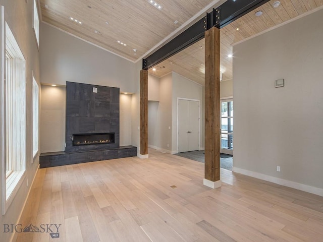 unfurnished living room featuring hardwood / wood-style floors, high vaulted ceiling, and wooden ceiling