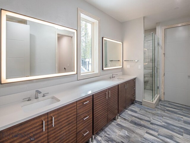 bathroom featuring vanity and a shower with shower door