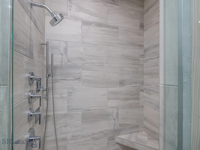 bathroom with a tile shower