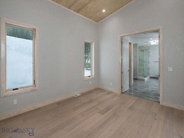 spare room featuring wood ceiling and light wood-type flooring