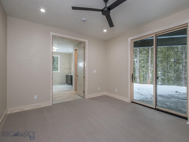 unfurnished room with ceiling fan and light colored carpet