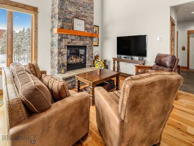 living room featuring a stone fireplace