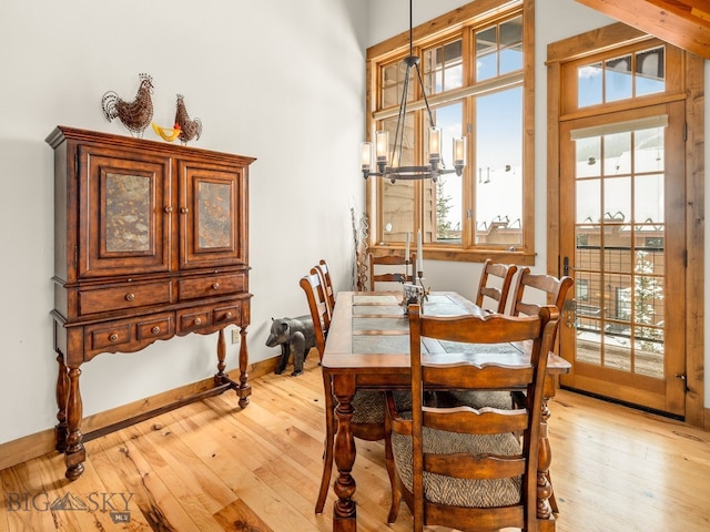 dining area featuring a chandelier and light wood-type flooring