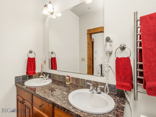 bathroom with dual bowl vanity and radiator